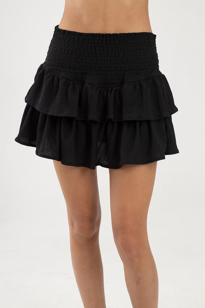 Falda negra con boleros en tela polyester y pretina elástica  Salar