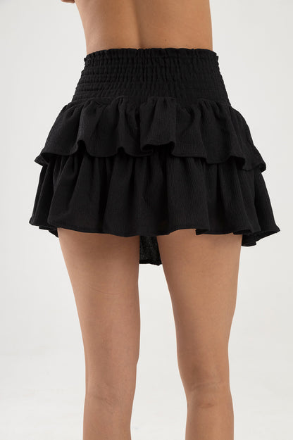 Falda negra con boleros en tela polyester y pretina elástica  Salar